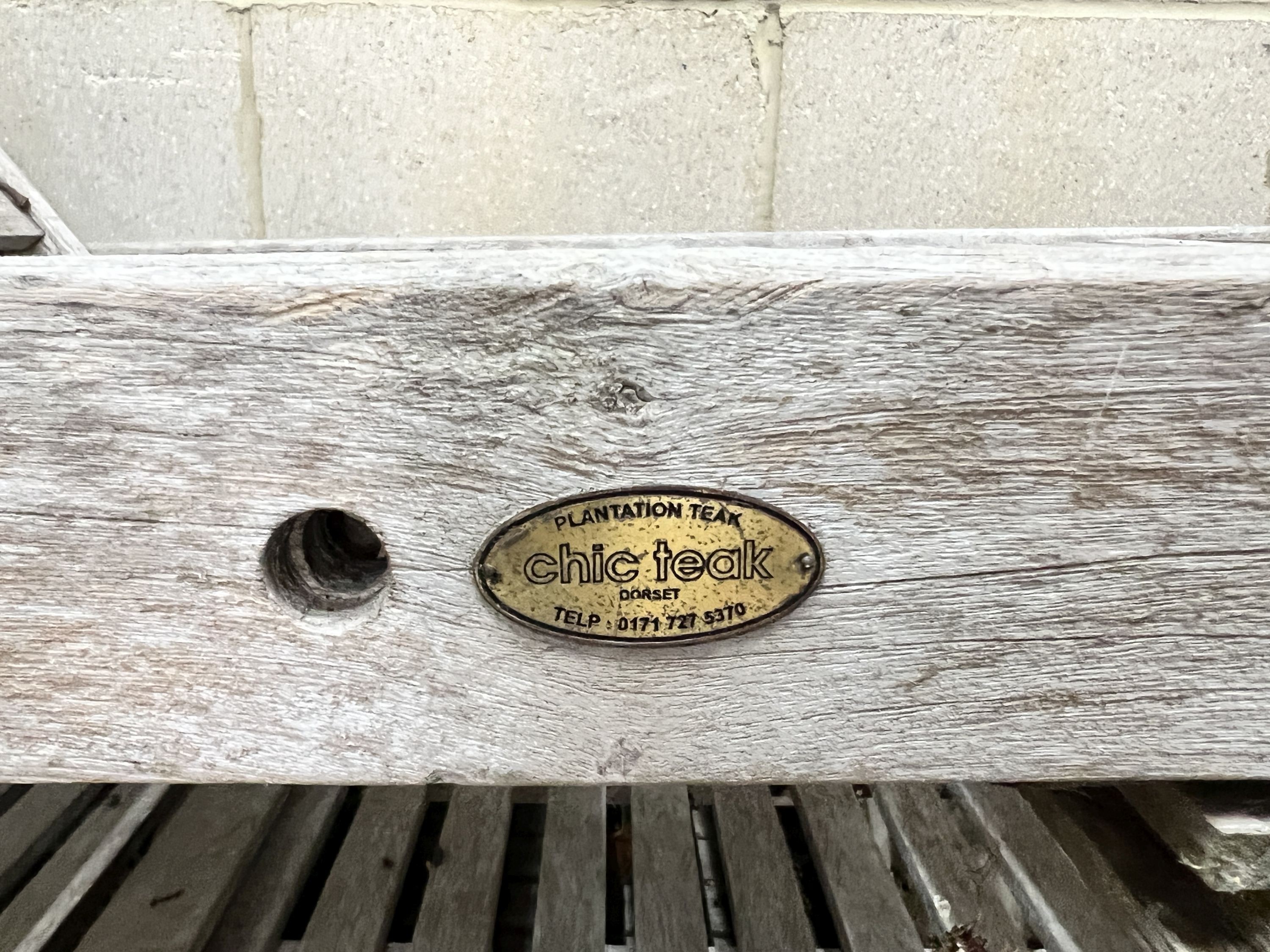 A pair of weathered teak garden loungers